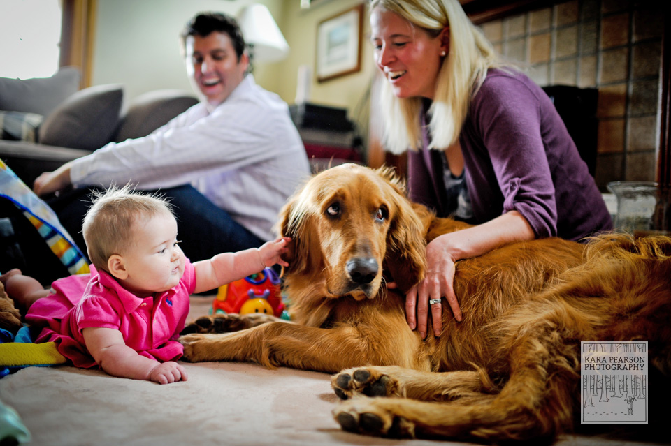 baby with her dog and parents