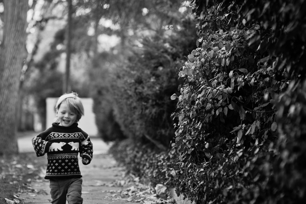 little boy running in park hill denver