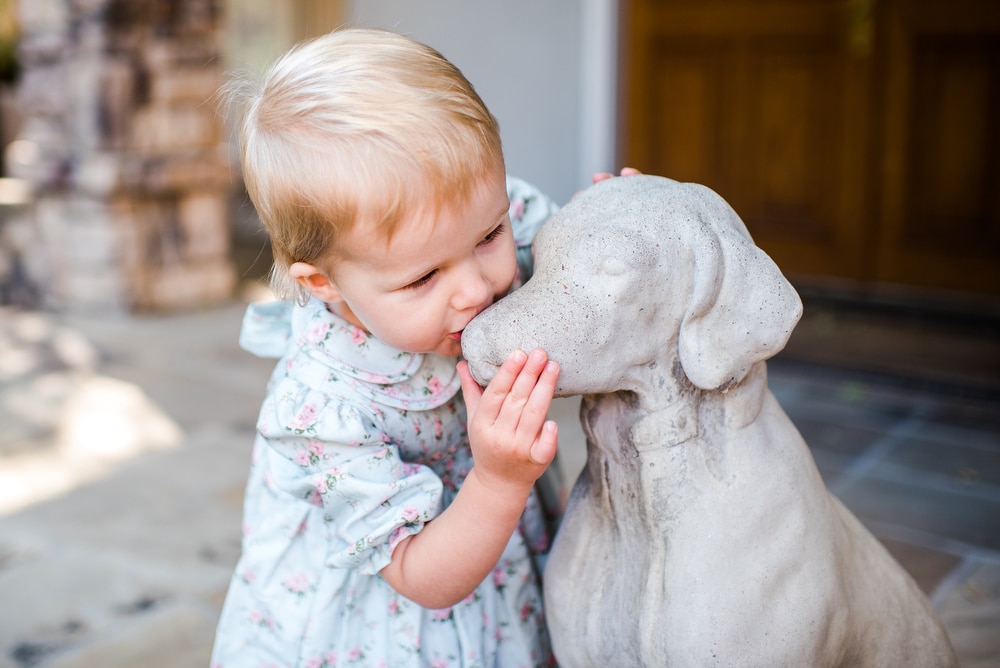 daughter kissing dog statue