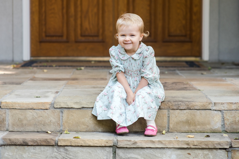 little girl sitting on steps
