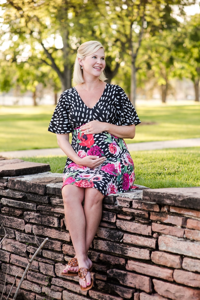 a woman poses for her Denver maternity portraits in Wash Park